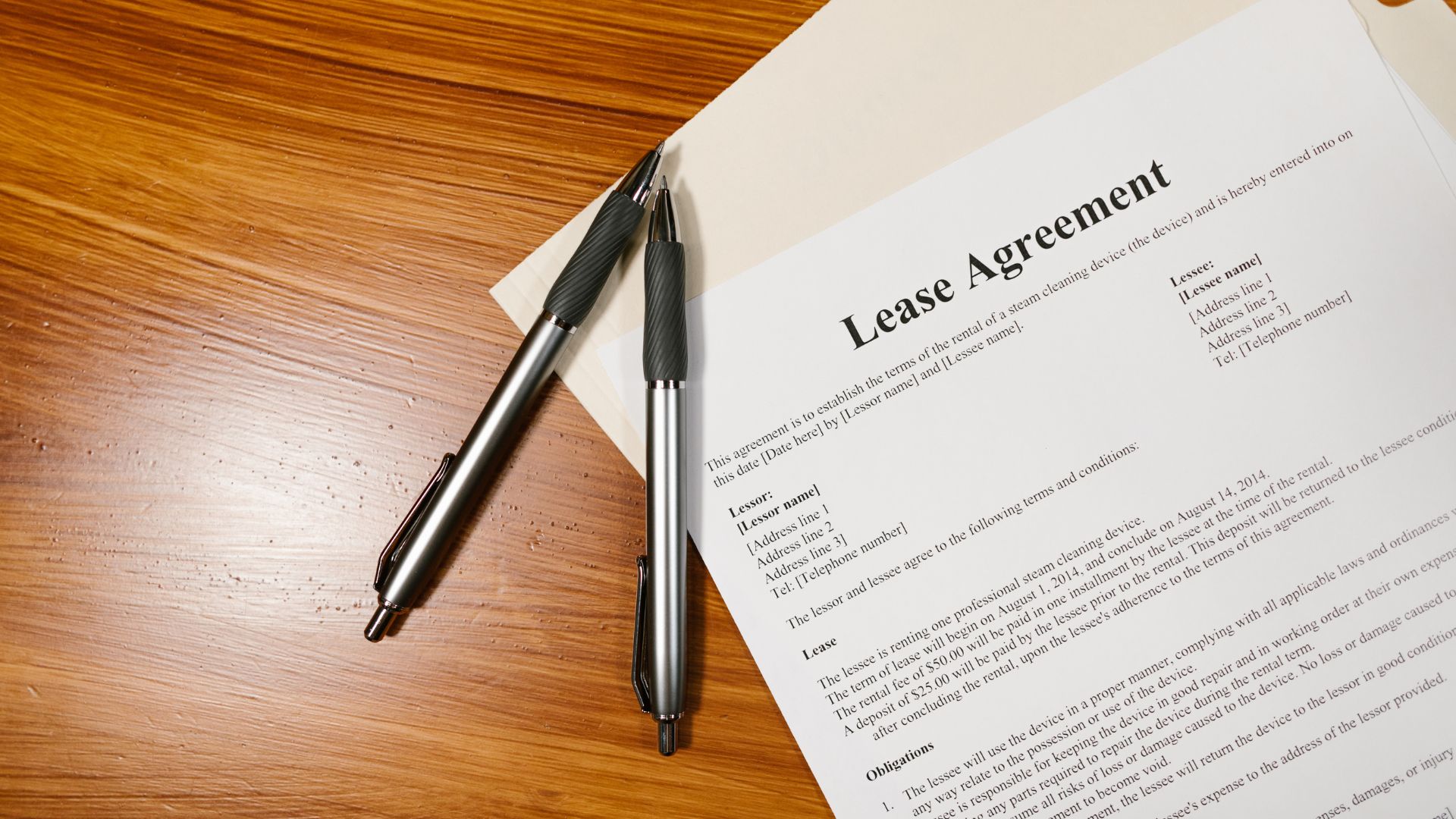lease agreement on a desk with two pens